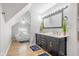 Bright bathroom features a double vanity, soaking tub, and wood-look flooring, creating a modern, spa-like retreat at 2155 S Delaware St, Indianapolis, IN 46225