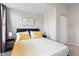 Bedroom with gray curtains, bedside tables, and a bed with yellow accents offers a calming and inviting space at 2155 S Delaware St, Indianapolis, IN 46225