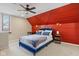Cozy bedroom featuring a striking accent wall, plush bedding, and great lighting at 2155 S Delaware St, Indianapolis, IN 46225