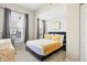 Bedroom features a large window, bedside tables with lamps, and a comfortable bed with a patterned yellow cover at 2155 S Delaware St, Indianapolis, IN 46225