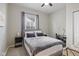 Comfortable bedroom with a window, bedside table, and workspace creates a functional and inviting living space at 2155 S Delaware St, Indianapolis, IN 46225
