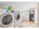 Bright laundry room showcasing modern washer and dryer, with natural light enhancing the space at 2155 S Delaware St, Indianapolis, IN 46225