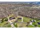 Aerial view of two homes with landscaped yards, long driveways, surrounded by mature trees and wooded area at 2525 Sunderland Dr, Martinsville, IN 46151