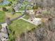 Aerial view of a community with winding roads, well-manicured lawns, ponds and a variety of home styles at 2525 Sunderland Dr, Martinsville, IN 46151