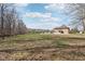 Sprawling backyard featuring a tree-lined perimeter and the house in the distance at 2525 Sunderland Dr, Martinsville, IN 46151