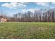 Large backyard with mature trees, offering plenty of space for outdoor activities and privacy at 2525 Sunderland Dr, Martinsville, IN 46151