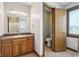Bathroom features a vanity with sink, a window, and an open doorway to the toilet at 2525 Sunderland Dr, Martinsville, IN 46151
