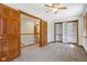 Bedroom features a closet with shelving, window, ceiling fan, and carpet at 2525 Sunderland Dr, Martinsville, IN 46151
