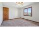This carpeted bedroom has a ceiling fan, one window and wood trim around the door and floor at 2525 Sunderland Dr, Martinsville, IN 46151