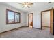 This bedroom has a neutral carpet, a ceiling fan and an ensuite bathroom at 2525 Sunderland Dr, Martinsville, IN 46151