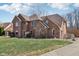 Side view of a brick and vinyl-sided home with a well-manicured lawn at 2525 Sunderland Dr, Martinsville, IN 46151