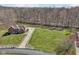 Well-maintained home with a long driveway and expansive lawn, nestled among mature trees at 2525 Sunderland Dr, Martinsville, IN 46151