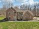Elegant two-story brick home with a well-manicured lawn and mature trees at 2525 Sunderland Dr, Martinsville, IN 46151