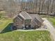 Stunning brick two-story home with an attached garage surrounded by a green lawn and mature trees at 2525 Sunderland Dr, Martinsville, IN 46151