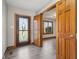 Inviting foyer featuring wood-look floors, decorative front door and natural wood trim at 2525 Sunderland Dr, Martinsville, IN 46151