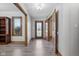 Inviting foyer with wood-look floors, decorative front door, and natural wood trim at 2525 Sunderland Dr, Martinsville, IN 46151