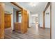 Bright foyer with wood-look floors, natural wood trim and views to other rooms at 2525 Sunderland Dr, Martinsville, IN 46151