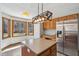 Kitchen with an island, wood cabinets, and stainless steel refrigerator at 2525 Sunderland Dr, Martinsville, IN 46151