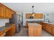 Well-lit kitchen boasts wood cabinets, stainless steel refrigerator, and open layout to living spaces at 2525 Sunderland Dr, Martinsville, IN 46151