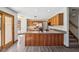 Bright kitchen features wood cabinets, an island, and access to living spaces and stairs at 2525 Sunderland Dr, Martinsville, IN 46151