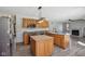 Open kitchen featuring wood cabinets, stainless steel appliances, large sink and updated lighting at 2525 Sunderland Dr, Martinsville, IN 46151