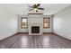 Inviting living room features a stone fireplace, two windows, ceiling fan, and modern flooring at 2525 Sunderland Dr, Martinsville, IN 46151