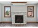Living room showcases a stone fireplace, two windows and modern flooring at 2525 Sunderland Dr, Martinsville, IN 46151