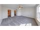 Spacious bedroom featuring neutral carpet and a window that allows natural light to brighten the space at 2623 E Bristlecone Dr, Indianapolis, IN 46217