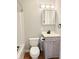 Full bathroom with a light wood vanity, updated fixtures and white tiling around the shower and bathtub at 2638 Calbert Dr, Indianapolis, IN 46219