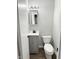 Clean half bathroom featuring a modern vanity and fixtures with wood-look flooring at 2638 Calbert Dr, Indianapolis, IN 46219