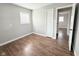 This bedroom features wood-look flooring, closet, fresh paint, and a large window at 2638 Calbert Dr, Indianapolis, IN 46219