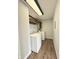 Efficient laundry room featuring a washer, dryer, wood-look flooring and wood cabinets at 2638 Calbert Dr, Indianapolis, IN 46219