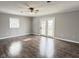 Large living room features french doors, natural light, and ceiling fan at 2638 Calbert Dr, Indianapolis, IN 46219