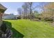 Spacious backyard with a large green lawn and mature trees at 3013 Crimson W Ct # 42, Carmel, IN 46033