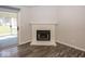 Close-up of a white brick fireplace and luxury wood flooring at 3013 Crimson W Ct # 42, Carmel, IN 46033