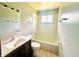 A well lit bathroom features a tub/shower, vanity, toilet, window and accessories at 3201 N Hawthorne Ln, Indianapolis, IN 46218