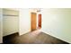 A clean bedroom features neutral carpet, an open closet, and a light-filled doorway at 3201 N Hawthorne Ln, Indianapolis, IN 46218