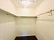 A walk-in closet painted in neutral colors, includes ample overhead storage space at 3201 N Hawthorne Ln, Indianapolis, IN 46218