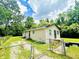 Side view of house with chain link fence and lush lawn on a sunny day at 3201 N Hawthorne Ln, Indianapolis, IN 46218