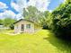 View of single-story house surrounded by mature trees and lush, green lawn at 3201 N Hawthorne Ln, Indianapolis, IN 46218