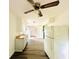 A kitchen with light wood-look floors features white cabinets and a ceiling fan at 3201 N Hawthorne Ln, Indianapolis, IN 46218