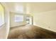 Cozy living room features neutral carpet, white walls, and natural lighting at 3201 N Hawthorne Ln, Indianapolis, IN 46218