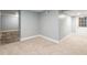 Partially finished basement with carpeted floors and exposed brick section at 350 N Belleview Pl, Indianapolis, IN 46222