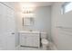 Bright bathroom featuring a white vanity, toilet, and a well-lit mirror, complemented by a large window at 350 N Belleview Pl, Indianapolis, IN 46222