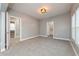 The bedroom boasts soft carpeting, access to multiple rooms, and neutral gray walls, creating a welcoming atmosphere at 350 N Belleview Pl, Indianapolis, IN 46222