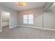 Bedroom showcases soft gray walls, plush carpeting, and ample natural light from two well-placed windows at 350 N Belleview Pl, Indianapolis, IN 46222