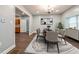 Charming dining room with modern lighting, a stylish table set, and a view to the kitchen at 350 N Belleview Pl, Indianapolis, IN 46222