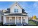 Charming two-story home featuring a covered front porch and classic architectural details at 350 N Belleview Pl, Indianapolis, IN 46222