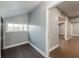 Hallway with gray walls and dark wood floors, leading to rooms bathed in natural light through a large window at 350 N Belleview Pl, Indianapolis, IN 46222