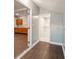 Hallway featuring wood floors, view to the kitchen with wood cabinetry, and glass door shower in the bathroom at 350 N Belleview Pl, Indianapolis, IN 46222